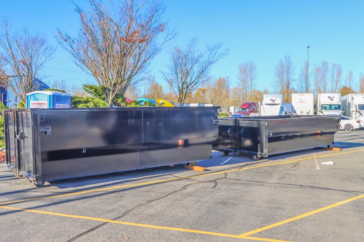 Professional dumpster rental service with roll-off container on residential driveway in West Haven